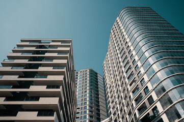 Contemporary residential buildings exterior in the daylight. Modern European residential apartment buildings quarter on a sunny day. Bottom view.