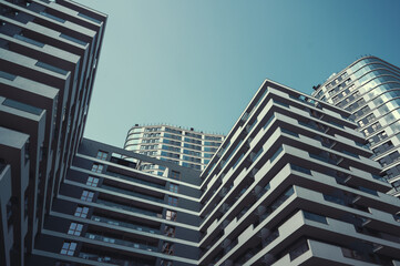 Contemporary residential buildings exterior in the daylight. Modern European residential apartment buildings quarter on a sunny day. Bottom view.