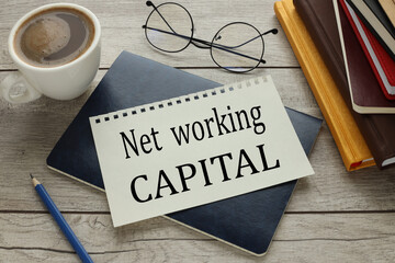 paper with text on a notepad on the desk NET WORKING CAPITAL