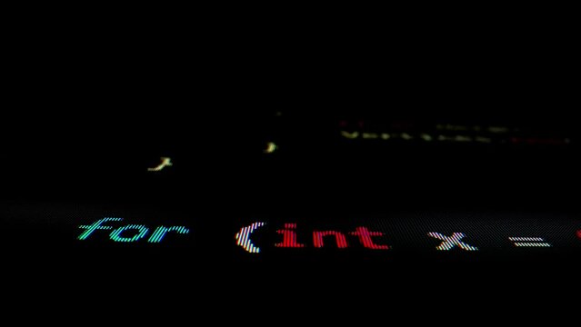 Closeup macro shot movement of coding script moving across LED screen with real-time AI-generated typing, showcasing advanced AI learning in optimization, debug and coding for software development.