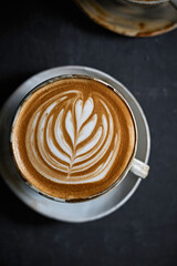 hot latte art coffee on dark background