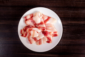The soft pork slides inside dish. The streaky pork for shabu hotpot