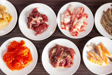 Set of raw food for shabu and Barbecue buffet. marinated pork. soft pork and salmon. Thailand food style. Moo Ka Ta