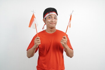 Men celebrating independence carrying red and white flags.