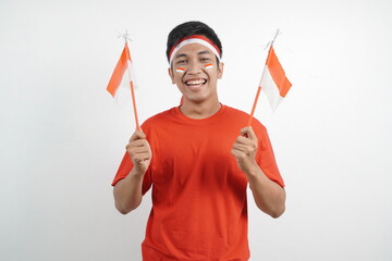 Men celebrating independence carrying red and white flags.