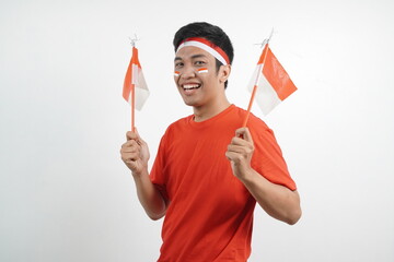 Men celebrating independence carrying red and white flags.