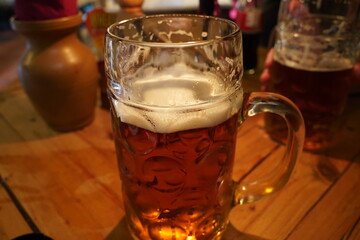Czech-style Pilsner lager golden beer on table of bar pub restaurant in Prague, Czech Republic.
