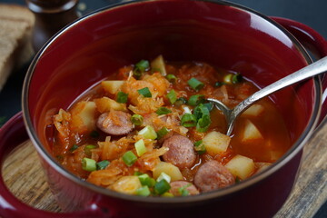 Czech cabbage soup Zelnacka or  Bohemian cabbage soup with potatoes, smoked bacon, sausages and vegetables