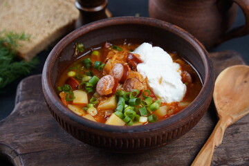 Czech cabbage soup Zelnacka or  Bohemian cabbage soup with potatoes, smoked bacon, sausages and vegetables