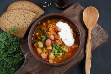 Czech cabbage soup Zelnacka or  Bohemian cabbage soup with potatoes, smoked bacon, sausages and vegetables