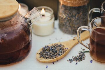 Natural herbal lavender tea on a white wooden tray in a middle of beautiful purple lavender field.