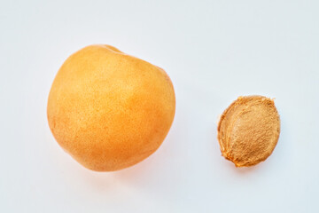 Apricot and its stone on a white background. View from above. Vitamin B 17. Healthy food background.