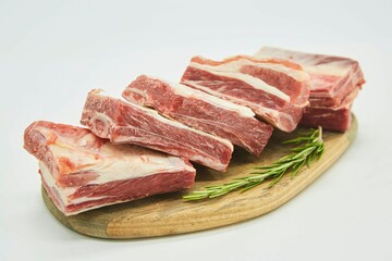 Fototapeta premium Raw meat on a white background. Pork, beef or lamb. Steak or tenderloin. Different parts of meat products for different dishes.