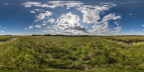 spherical 360 hdri panorama among green grass farming field near melioration reclamation canal in...