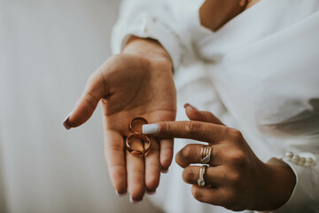 wedding rings in the hands of the bride