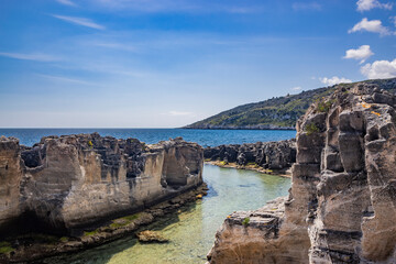 The amazing natural pools of Marina Serra, in Puglia, Salento, Tricase. The clear and crystalline turquoise sea, between the rocky cliff. The blue sky, in the summer.