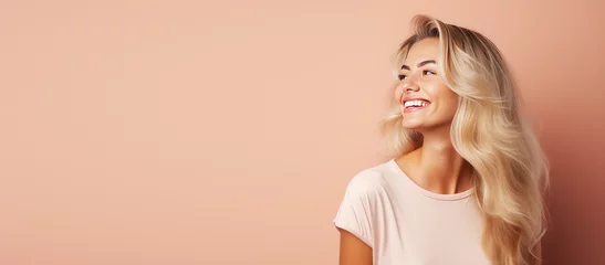 Fotobehang Smiling young woman with blonde long groomed hair isolated on pastel flat background with copy space. Blonde hair care products banner template, hair salon. © SnowElf