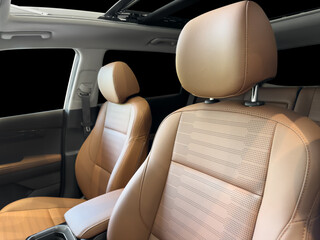 Modern luxury car brown leather interior. Part of orange leather car seat details with white...