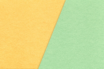 Fototapeta premium Texture of craft light yellow and green paper background, half two colors, macro. Vintage kraft mint cardboard.