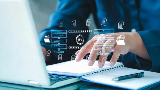 Businessman checking data transfer using laptop computer with data server storage icon for data exchange and transfer concept.