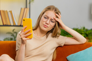 Sad displeased woman use smartphone typing browsing, loses becoming surprised sudden lottery...