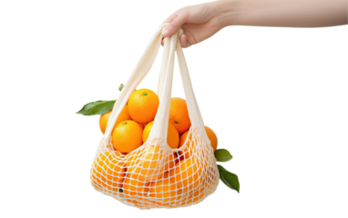 Hand holding an eco-friendly string bag filled with oranges isolated on a transparent background 