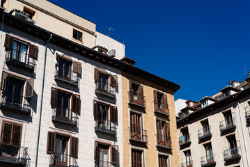 Fototapeta na wymiar Luxury old residential buildings in Serrano Street in Salamanca neighborhood in central Madrid. Low angle view against sky
