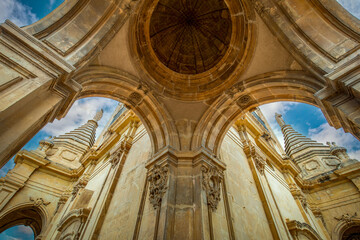 Obraz premium Detail of the second body of the tower of the cathedral of Santa Maria de Murcia, Spain, in baroque style with niches and saints in the domes