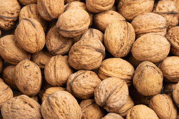 Walnut background. Pile of nuts filling the frame.