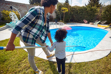 Mother and Daughter Cleaning the Pool with Dedication