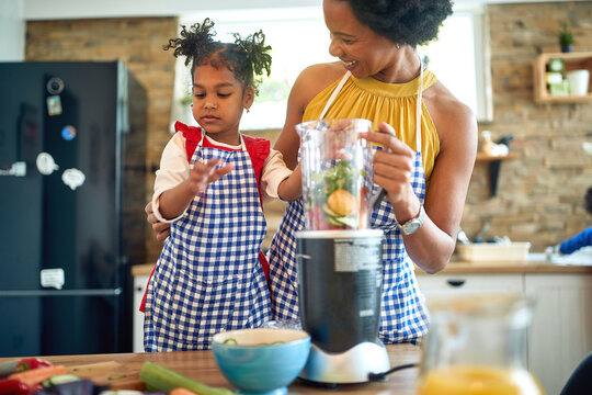 Afro-American Mother and Little Girl Creating Vegan Magic with Fresh Vegetables - Powered by Adobe