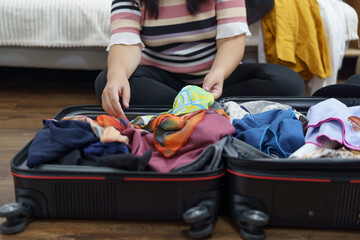 Woman packs baggage in suitcase for new journey packing a luggage travel plans vacation