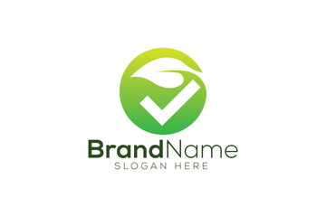 Fototapeta premium Green leaf and tick mark logo design vector template