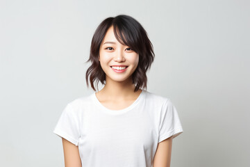 a lively Asian teen with short hair, donning a white T-shirt, standing against a clean white studio backdrop, beautifully lit. Perfect for a wide range of projects. generative AI.