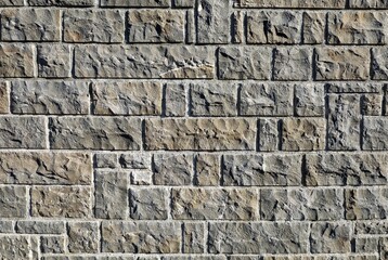 Stone wall made of square and rectangle rough granite blocks. Background and texture.