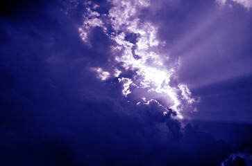 Naklejka na ściany i meble sun shining through clouds