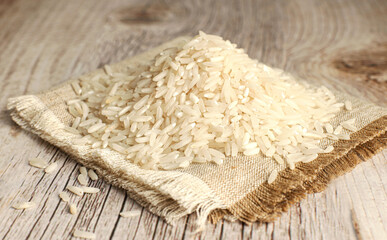 White rice on wooden background