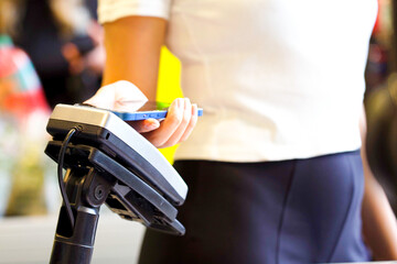 Close-up of unrecognizable woman using modern gadget while making payment