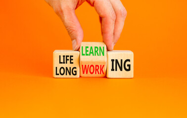 Lifelong learning working symbol. Concept word Lifelong learning working on block on a beautiful orange background. Businessman hand. Business educational lifelong learning working concept. Copy space