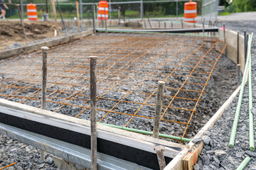 Welded wire mesh, WWM, installed within a sidewalk concrete form prior to the installation of concrete. 