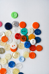 Multicolored buttons on a white background. Round buttons from clothes.