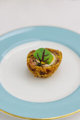 A small pastry with micro green served during afternoon tea