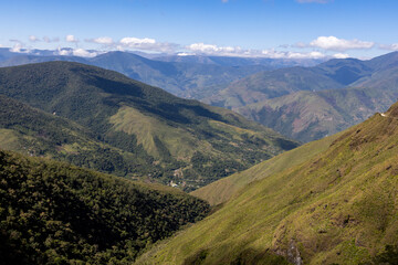 Obraz premium Scenic drive through the remote Bolivian Andes: passing small settlements, forested mountains, rivers and coca plantations on steep hills