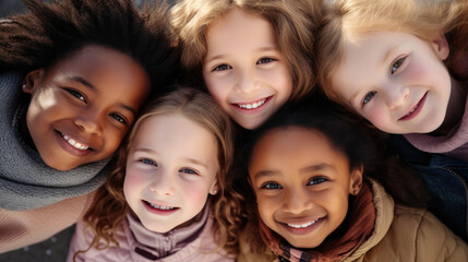 Obraz premium Group of diverse kids smiling at camera, top view