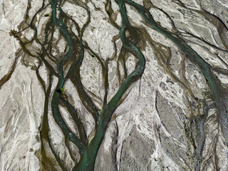Close up aerial view of the Rio Sacambaya landscape with a huge riverbed and river channels branching in the Bolivian Andes in South America