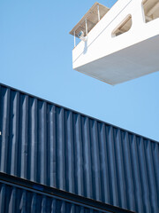 Side wing of navigational bridge and and blue containers stored on deck of ultra large containers ship © Maritime Art Blog