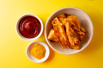 Top view Delicious Fried Cassava in Handcrafted White Ceramic Bowl on Yellow Studio Background