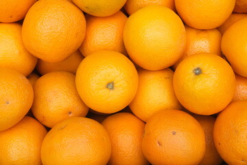 Pile of fresh ripe oranges as background, top down close up view