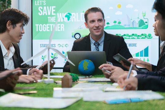 Diverse group of business people planning for alternative energy utilization for greener sustainable Earth by reducing CO2 emission and carbon credit with renewable clean energy technology. Quaint