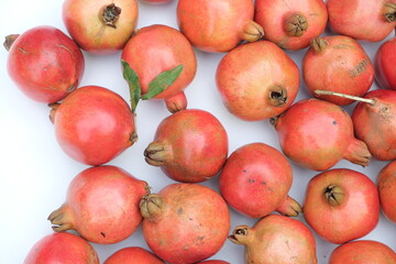 Fototapeta na wymiar Many red ripe pomegranate fruits as background